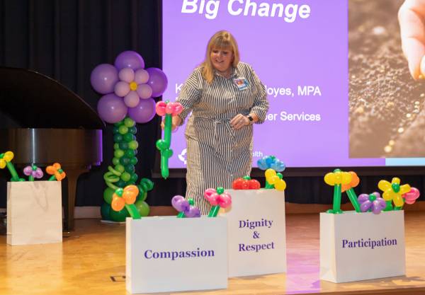 A patient advisor planting flowers
